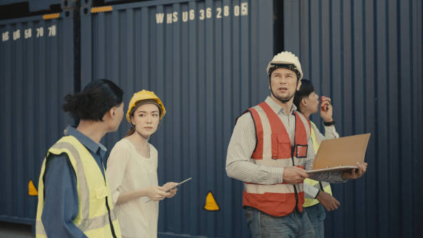 istock Group of multi-ethnic industrials check container working in the port. 1364517625