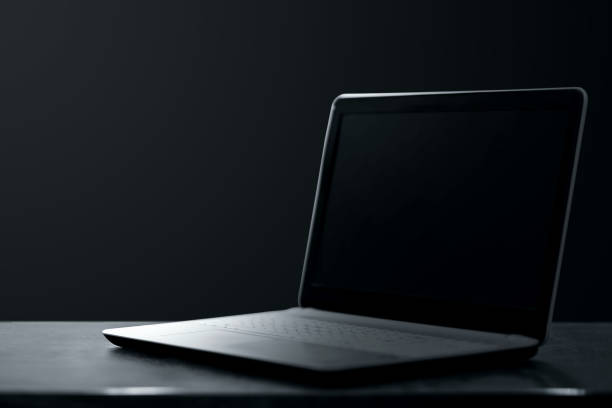 istock Creative background dark laptop stands on a dark background. Modern technology concept. 1364519438