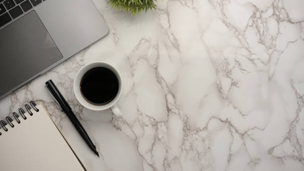 istock Office workspace with laptop and copy space on marble background. 1364521070