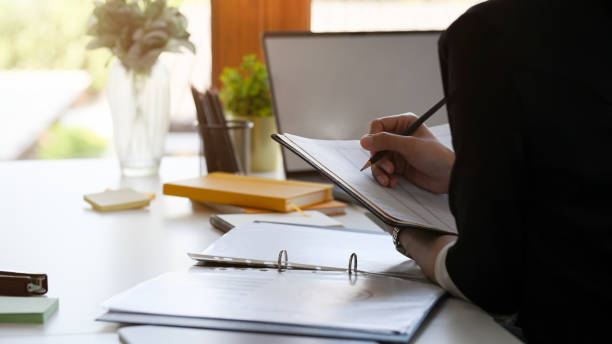 istock Close-up, a female assistant or secretary taking notes. 1364521095
