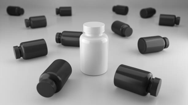 istock White mock up vitamin bottle surrounded by a black vitamin bottle. 1364521988