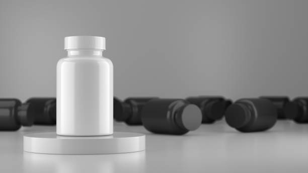 istock White mock up vitamin bottle surrounded by a black vitamin bottle. 1364522000