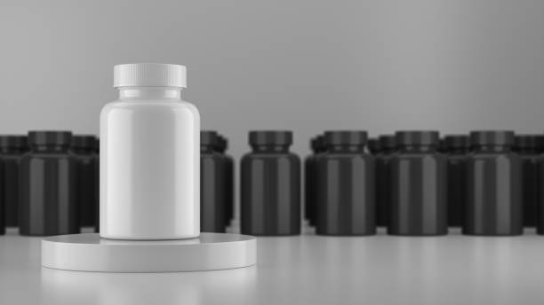 istock White mock up vitamin bottle surrounded by a black vitamin bottle. 1364522011