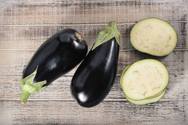istock black eggplant on wooden background 1364524296