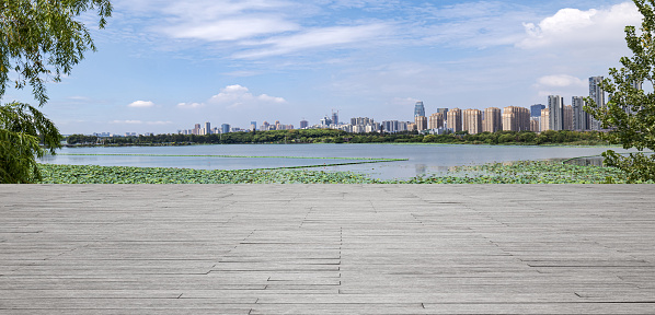 Empty wooden platform and modern skyscrapers background