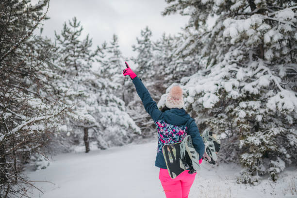 istock Young woman with snowboard 1364526733