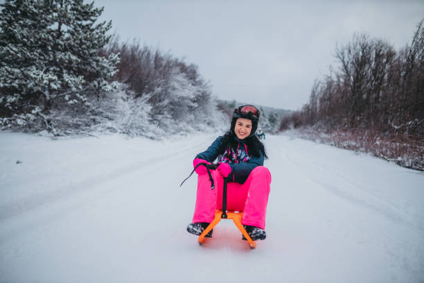 istock Young woman sledding downhill 1364526751