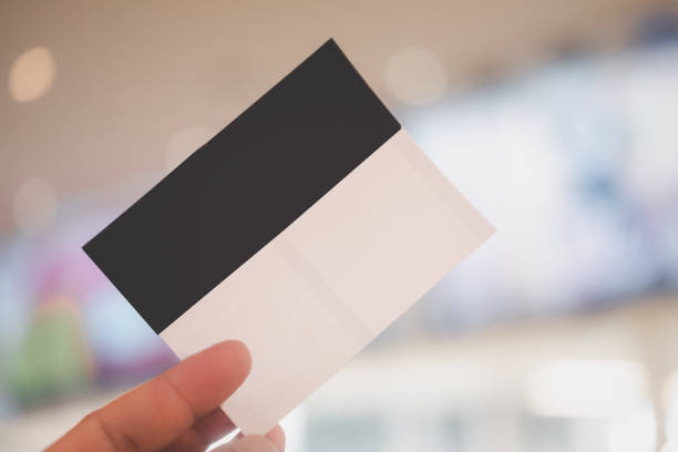 istock Hand holding up two movie ticket. 1364526992