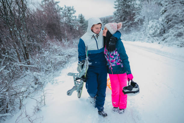istock Young couple is kissing in a winter forest 1364529088