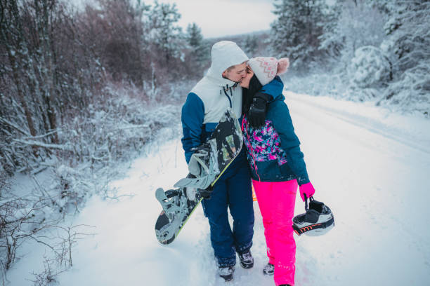 istock Young couple is kissing in a winter forest 1364529094