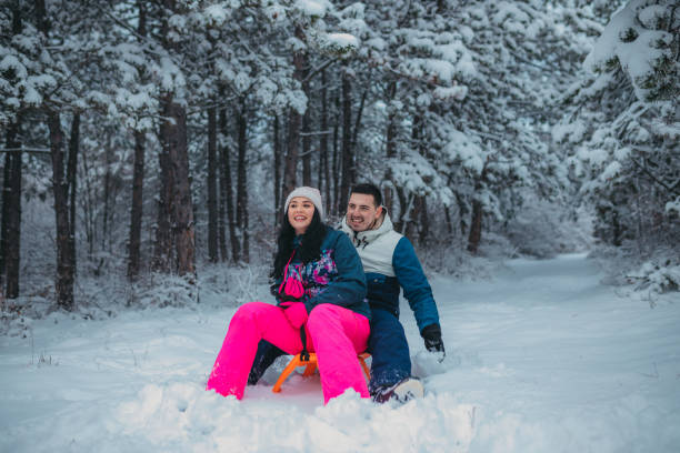 istock Happy young couple is ready for sledding in a winter day 1364530569