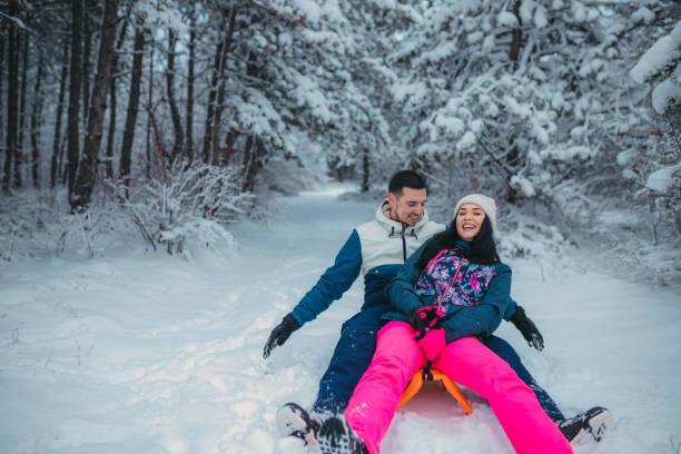 istock Happy young couple is ready for sledding in a winter day 1364530570