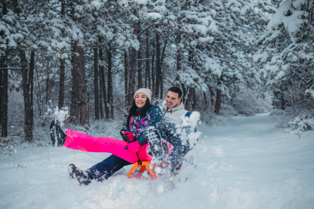 istock Happy young couple is ready for sledding in a winter day 1364530572