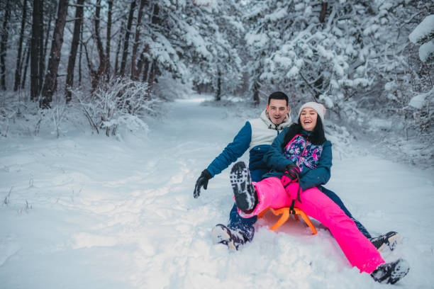 istock Happy young couple is ready for sledding in a winter day 1364530575