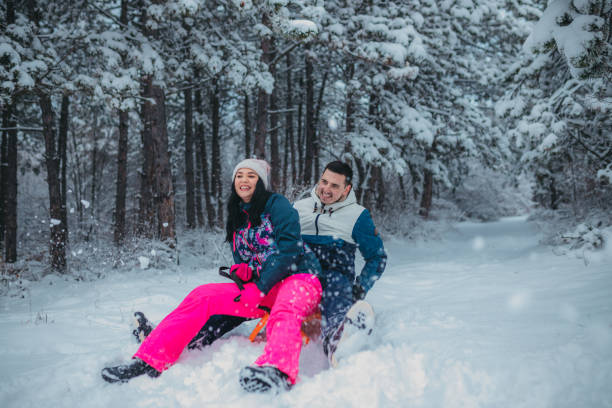 istock Happy young couple is ready for sledding in a winter day 1364530581