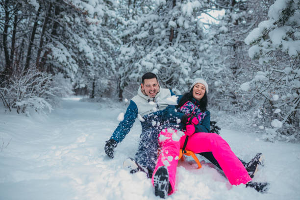 istock Happy young couple is ready for sledding in a winter day 1364530583