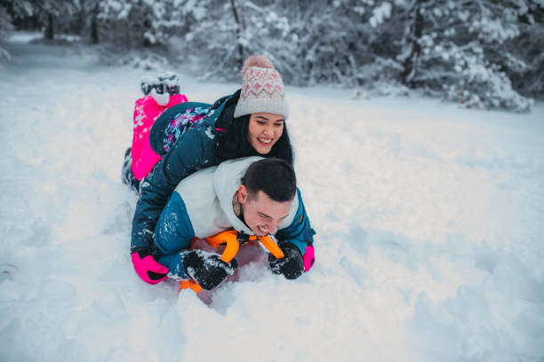 istock Happy young couple is ready for sledding in a winter day 1364530598