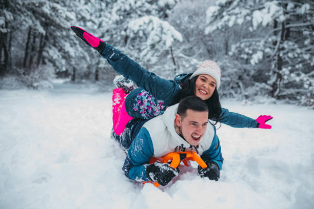 istock Happy young couple is ready for sledding in a winter day 1364530600
