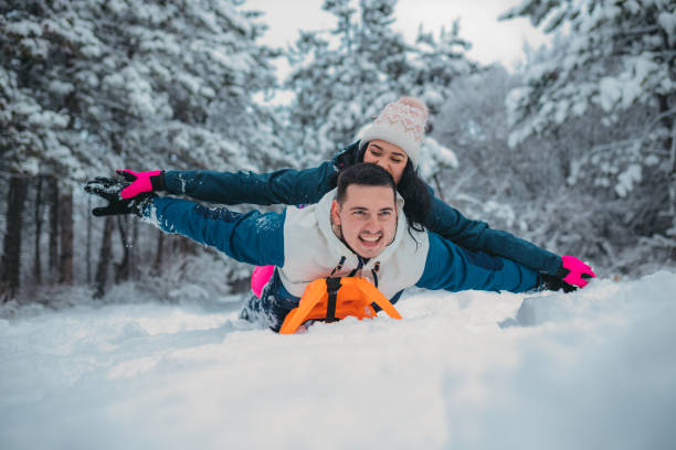 istock Happy young couple is ready for sledding in a winter day 1364530606