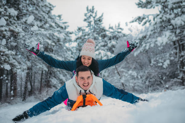 istock Happy young couple is ready for sledding in a winter day 1364530624