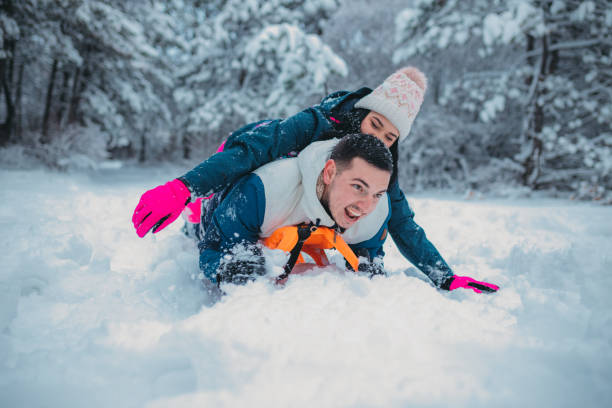 istock Happy young couple is ready for sledding in a winter day 1364530639