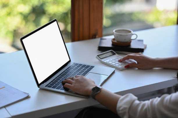istock Female accountant using calculator and working with computer laptop at office desk. 1364531721