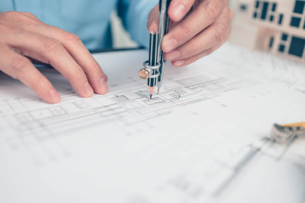 istock Architect engineer use compass drawing design working on blueprint. House planning design and construction concept. 1364532479