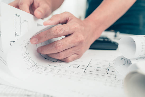 istock Architect engineer read drawing design working on bueprint. House planning design and construction concept. 1364534545