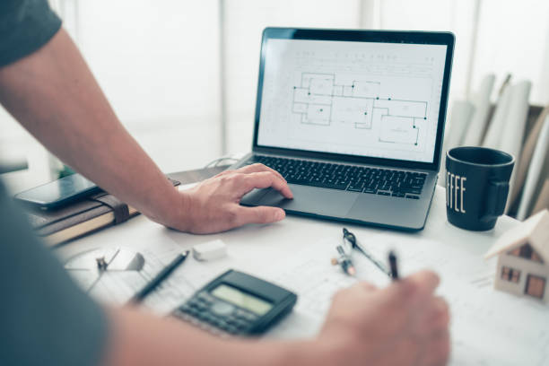 istock Architect engineer use laptop for check drawing design. House planning design and construction concept. 1364535498