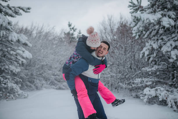 istock Young couple having fun outdoors at winter. Wearing warm clothes. Day time. 1364535530