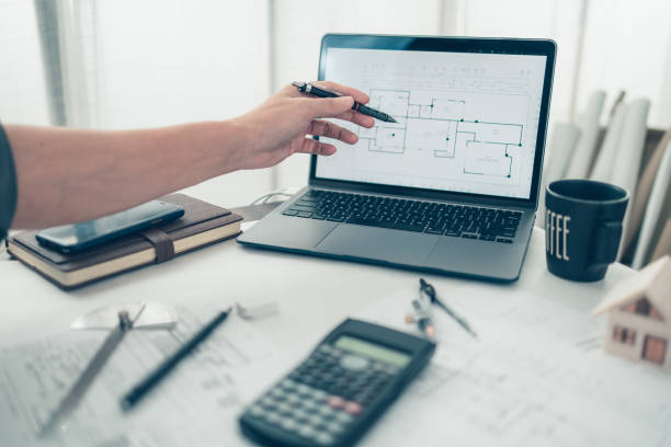istock Architect engineer use laptop for check drawing design. House planning design and construction concept. 1364535531