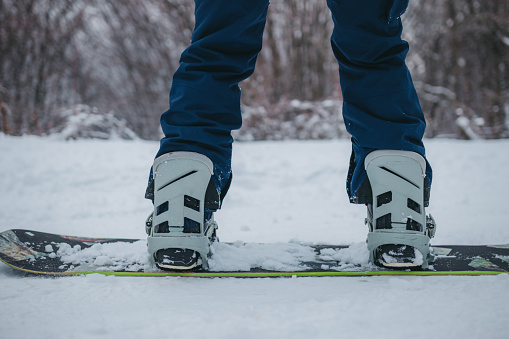 A man on a snowboard rides down the side of the mountain