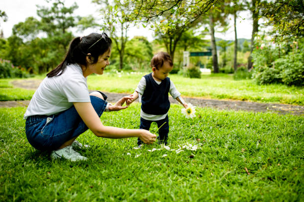 istock mother playing in park with her baby 1364536875
