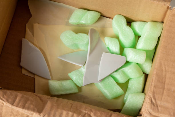 istock Fragments of broken dishes in a cardboard box 1364538937
