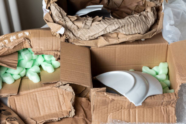Broken dish in a damaged cardboard box
