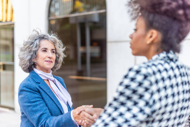 istock side view of two women agreeing to work together 1364539068