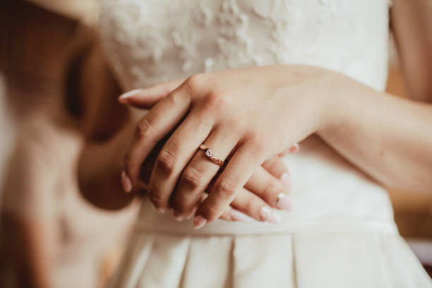 istock Engagement ring on bride hand. Manicure fingers preparation. Dressing up for wedding ceremony background. 1364539103
