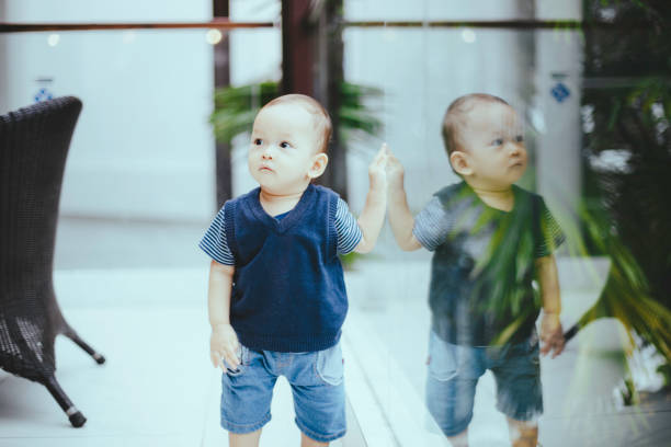 baby looking out glass door