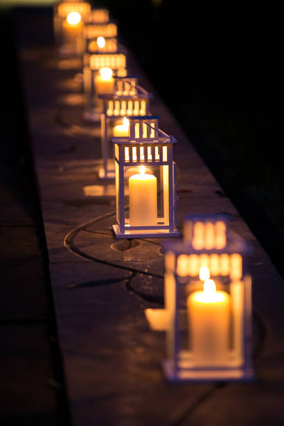 istock White lanterns in a row with warm candlelight 1364543235