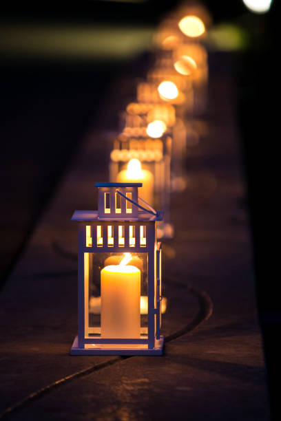 istock White lanterns in a row with warm candlelight 1364543237