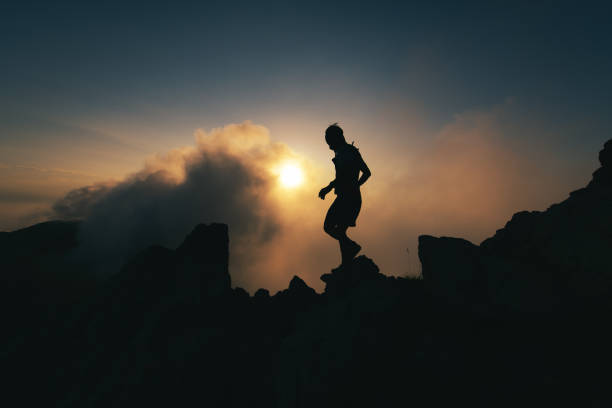 A man in silhouette walks a rocky ridge during a solitary meditation