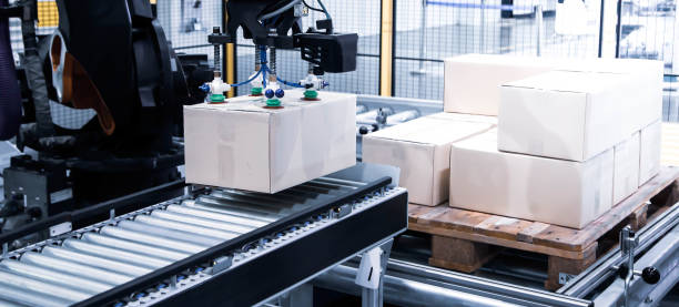 istock Industrial autonomous robot loading carton on conveyor 1364545676