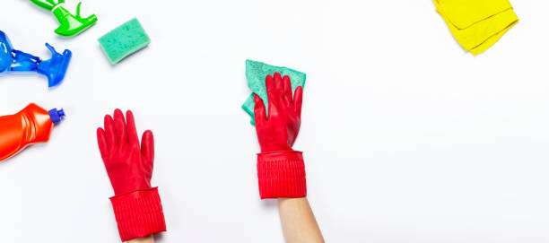 istock Female hands in red rubber protective gloves with a microfiber cloth isolated on white background top view copy space. Cleaning concept, household, cleaning company, detergents, cleaning accessories 1364545829