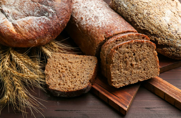 istock Different kinds of fresh bread on wooden table 1364545860