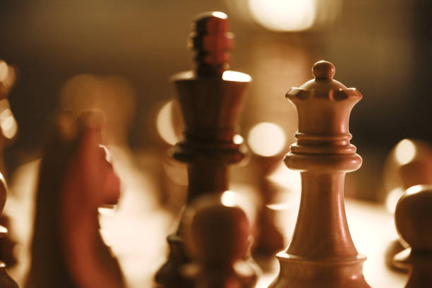 istock Wooden chess pieces on the chessboard and dim light 1364546229