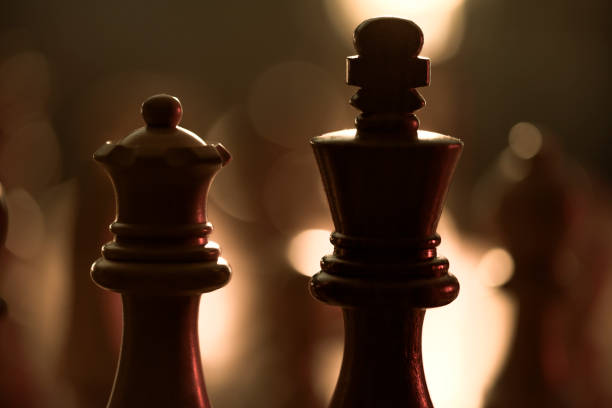 istock Wooden chess pieces on the chessboard and dim light 1364547220