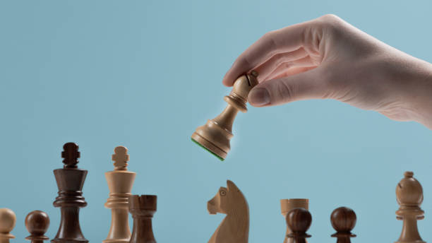 istock Player moving a pawn on the chessboard 1364547276