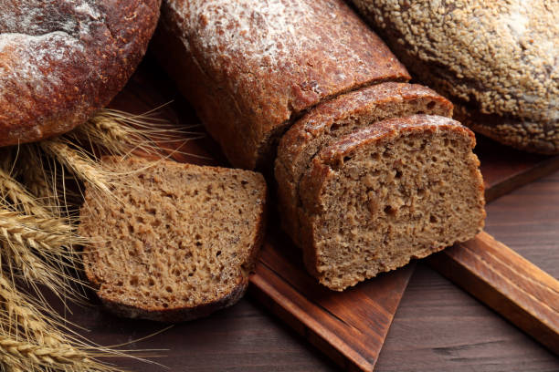 istock Tasty freshly baked bread on wooden table, closeup 1364548882