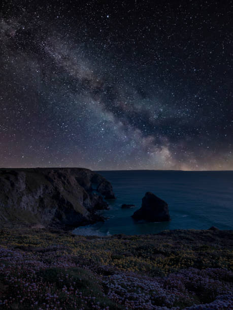 istock Digital composite image of Milky Way night sky over landscape image at Bedruthan Steps 1364549011