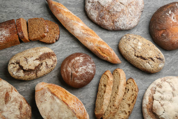 istock Different kinds of fresh bread on grey table, flat lay 1364550118